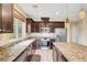 The spacious kitchen features stainless steel appliances, granite counters, and a large island with additional storage at 10247 Gladstone Peak St, Las Vegas, NV 89166