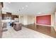 A spacious, open-concept kitchen and living room are divided by tile and wood flooring for an elegant and practical feel at 10247 Gladstone Peak St, Las Vegas, NV 89166