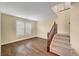 Bright living room featuring wood floors, window shutters, and a staircase at 10247 Gladstone Peak St, Las Vegas, NV 89166