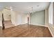 Bright living room featuring wood floors, a chandelier, and a staircase to the upper level at 10247 Gladstone Peak St, Las Vegas, NV 89166