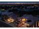 An aerial view of a lovely neighborhood, a golf course, and the city lights at night at 10421 Shoalhaven Dr, Las Vegas, NV 89134