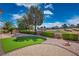 Landscaped backyard with manicured green shrubs and artificial grass near a golf course at 10421 Shoalhaven Dr, Las Vegas, NV 89134