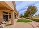 Scenic backyard featuring a covered patio, lush landscaping, and serene golf course views at 10421 Shoalhaven Dr, Las Vegas, NV 89134