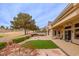 Private backyard with a covered patio, manicured landscaping, and views of the golf course at 10421 Shoalhaven Dr, Las Vegas, NV 89134