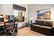 Inviting bedroom featuring a comfortable sofa, workspace, and well-lit with natural light at 10421 Shoalhaven Dr, Las Vegas, NV 89134