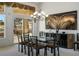 Elegant dining area featuring a glass top dining table and large windows looking onto the back patio at 10421 Shoalhaven Dr, Las Vegas, NV 89134