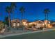 Inviting home exterior at twilight, showcasing desert landscaping and warm lighting at 10421 Shoalhaven Dr, Las Vegas, NV 89134
