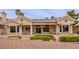 Beautiful home exterior with solar panels, lush greenery, and a charming patio area at 10421 Shoalhaven Dr, Las Vegas, NV 89134