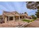 Charming home exterior featuring a tiled roof, manicured landscaping, and a inviting patio at 10421 Shoalhaven Dr, Las Vegas, NV 89134