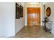 Inviting home entry with double wooden doors, beige tile flooring and neutral paint at 10421 Shoalhaven Dr, Las Vegas, NV 89134