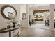 Home entry with tile flooring, a round mirror, and furniture leading into the living and dining areas at 10421 Shoalhaven Dr, Las Vegas, NV 89134