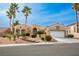 Beautiful one-story home with desert landscaping, concrete steps and tall palm trees under a bright blue sky at 10421 Shoalhaven Dr, Las Vegas, NV 89134