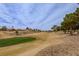 Picturesque view of the well-maintained golf course with beautiful green and beige fairways at 10421 Shoalhaven Dr, Las Vegas, NV 89134