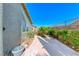 A view of the backyard with mature bushes and landscaping, desert landscaping and concrete at 10924 Bandol Pl, Las Vegas, NV 89141