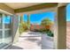 Covered backyard patio with view of desert landscaping and privacy wall, offering a serene outdoor space at 10924 Bandol Pl, Las Vegas, NV 89141