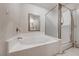 Bright bathroom showcasing a garden tub, separate glass-enclosed shower and mirror at 10924 Bandol Pl, Las Vegas, NV 89141