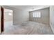 Neutral bedroom features a large window with shutters and neutral carpet at 10924 Bandol Pl, Las Vegas, NV 89141