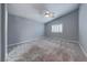 Main bedroom with vaulted ceilings, carpet floors, and large windows for natural light at 10924 Bandol Pl, Las Vegas, NV 89141