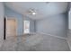 Primary bedroom with neutral walls, ceiling fan, and an ensuite bathroom at 10924 Bandol Pl, Las Vegas, NV 89141