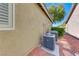 Exterior view of the home showing dual AC units, desert landscaping, and the property's exterior at 10924 Bandol Pl, Las Vegas, NV 89141