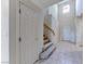 Bright foyer featuring tile flooring, staircase, and an open view to the entry door at 10924 Bandol Pl, Las Vegas, NV 89141