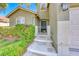 Charming home featuring a quaint front entrance with a gated porch and lush landscaping at 10924 Bandol Pl, Las Vegas, NV 89141