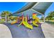 Neighborhood playground with colorful slides, climbing structures, and protective canopy for a fun experience at 10924 Bandol Pl, Las Vegas, NV 89141