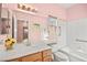 Well-lit bathroom with double sinks, large mirror, and combination tub and shower with grab bars at 1184 Warm Canyon Way, Las Vegas, NV 89123