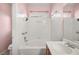 Clean bathroom features a bathtub with white tile surround and shower, vanity, and bright lighting at 1184 Warm Canyon Way, Las Vegas, NV 89123