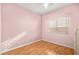Simple bedroom features natural light, hard wood floors, and calming color at 1184 Warm Canyon Way, Las Vegas, NV 89123