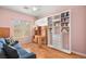 Versatile bedroom with built-in shelving, desk, and a comfortable sitting area with natural light at 1184 Warm Canyon Way, Las Vegas, NV 89123