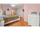 Cozy bedroom with hardwood floors, ceiling fan, and ensuite bathroom access, and dresser at 1184 Warm Canyon Way, Las Vegas, NV 89123