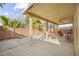 Enjoy outdoor living on this covered patio with fan, seating and views of the backyard at 1184 Warm Canyon Way, Las Vegas, NV 89123