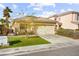 Lovely single-Gathering home boasts a manicured lawn, mature trees, and an attached two-car garage at 1184 Warm Canyon Way, Las Vegas, NV 89123