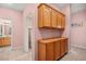 Hallway offers built-in cabinets, neutral tile flooring, and access to laundry room and bathroom at 1184 Warm Canyon Way, Las Vegas, NV 89123