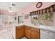 Kitchen with oak cabinets, tile countertops, and a dining area at 1184 Warm Canyon Way, Las Vegas, NV 89123