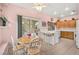 Cozy kitchen with light wood cabinets, tile floors, and a view of the backyard at 1184 Warm Canyon Way, Las Vegas, NV 89123