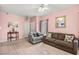 Bright and airy living room with tile flooring, neutral decor, and comfortable seating arrangements at 1184 Warm Canyon Way, Las Vegas, NV 89123