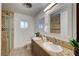 Bathroom featuring dual sinks, granite counters, and a glass-enclosed shower at 1401 S 17Th St, Las Vegas, NV 89104