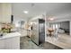 Modern kitchen featuring stainless steel appliances, stone tile floor, and adjacent dining area at 1401 S 17Th St, Las Vegas, NV 89104
