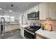 Modern kitchen featuring sleek appliances, light wood cabinets and stone tile flooring at 1401 S 17Th St, Las Vegas, NV 89104