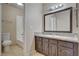 Well-lit bathroom showcasing a sink with granite counters and white tiled tub/shower at 1405 Vegas Valley Dr # 170, Las Vegas, NV 89169