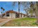 A row of multi-Gathering homes with red tile roofs, green grass, palm trees, blue sky and walkways at 1405 Vegas Valley Dr # 170, Las Vegas, NV 89169