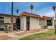 Multi-Gathering home with a red tile roof, palm trees, walkways and a green lawn on a sunny day at 1405 Vegas Valley Dr # 170, Las Vegas, NV 89169