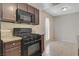Shows a stove with granite countertops and dark cabinets at 1405 Vegas Valley Dr # 170, Las Vegas, NV 89169