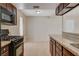 Kitchen featuring dark wood cabinets, granite counters, tile floors, and stainless appliances at 1405 Vegas Valley Dr # 170, Las Vegas, NV 89169