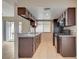 Galley kitchen featuring dark wood cabinets, tile floors, granite counters and stainless appliances at 1405 Vegas Valley Dr # 170, Las Vegas, NV 89169