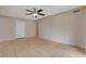 Neutral living room featuring tile flooring, a ceiling fan, and a white door leading outside at 1405 Vegas Valley Dr # 170, Las Vegas, NV 89169