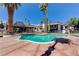 This image features an outdoor community pool surrounded by palm trees and condo buildings in sunny weather at 1405 Vegas Valley Dr # 170, Las Vegas, NV 89169