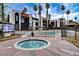 Community outdoor area features a pool, hot tub, and Spanish-style condominium buildings with palm trees at 1405 Vegas Valley Dr # 170, Las Vegas, NV 89169